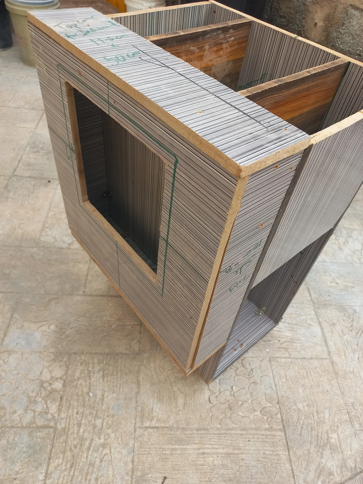 Angled view of the bin front face showing the large rectangular camera cutout opening, with the two upper compartments visible at the top