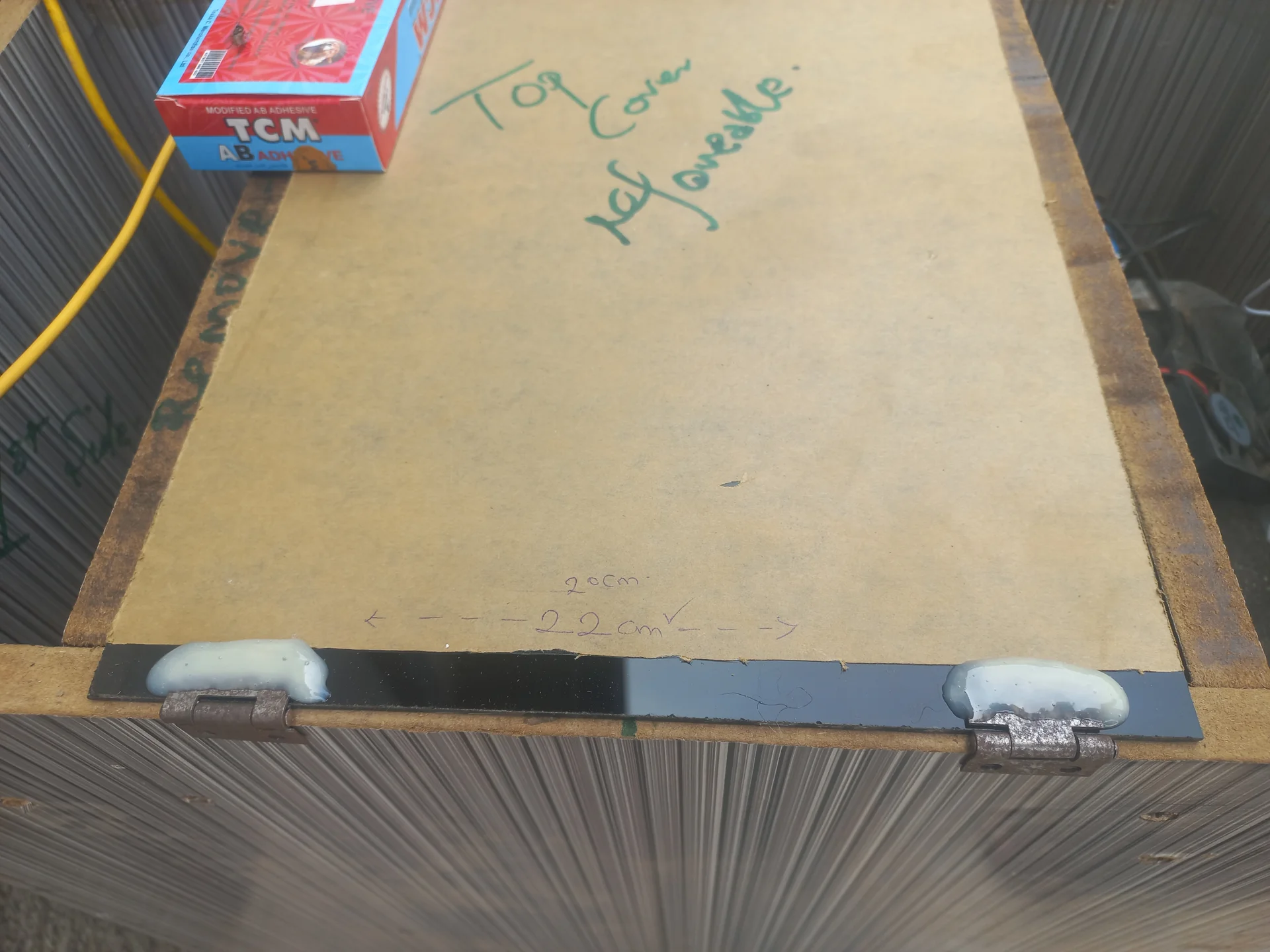 The bin top cover with the hinges now glued and set, photographed from above to show the hinge line
