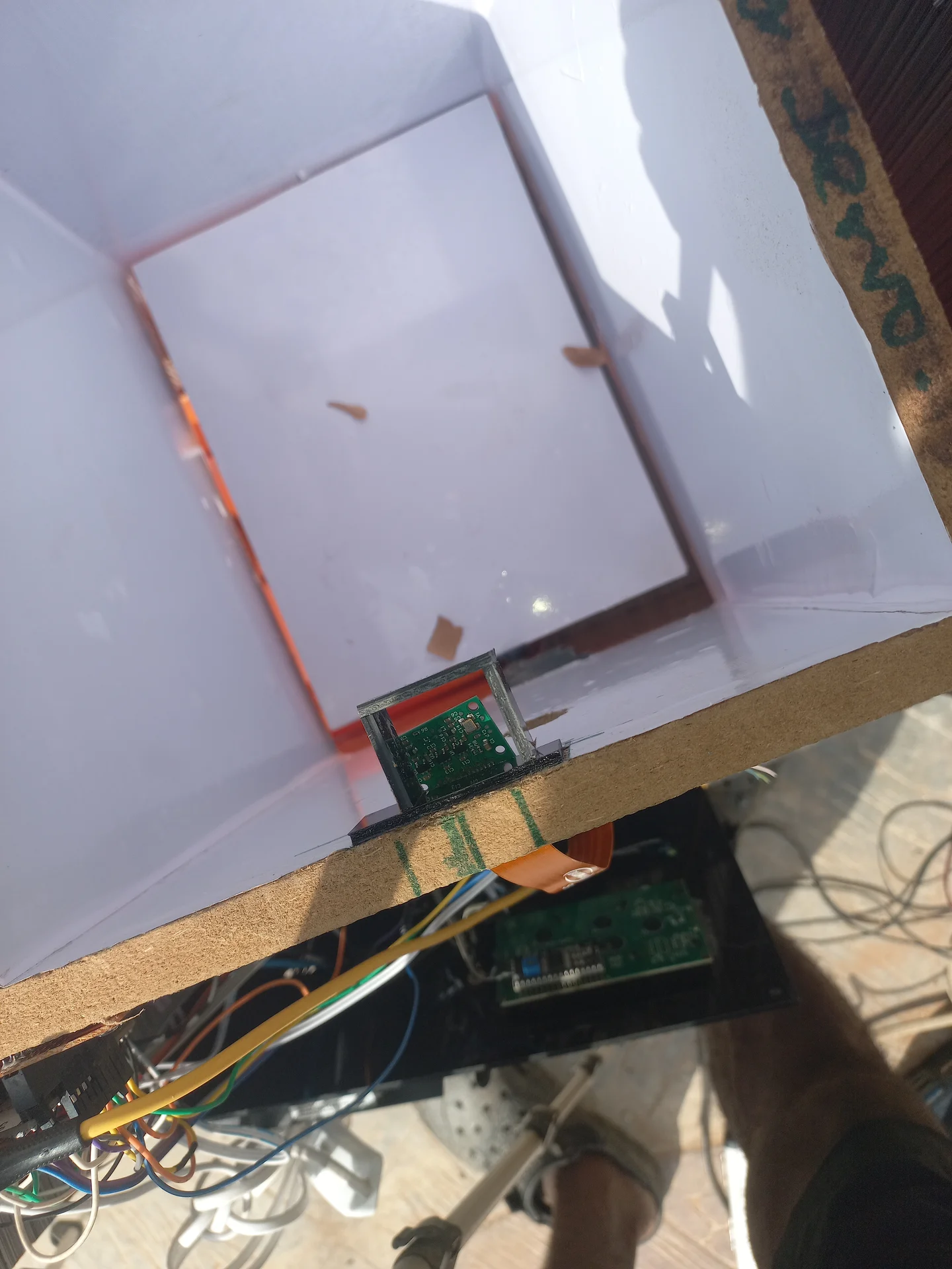 Interior view showing the orange CSI ribbon cable connecting the Pi Camera module at the top of the bin down to the Raspberry Pi board mounted below