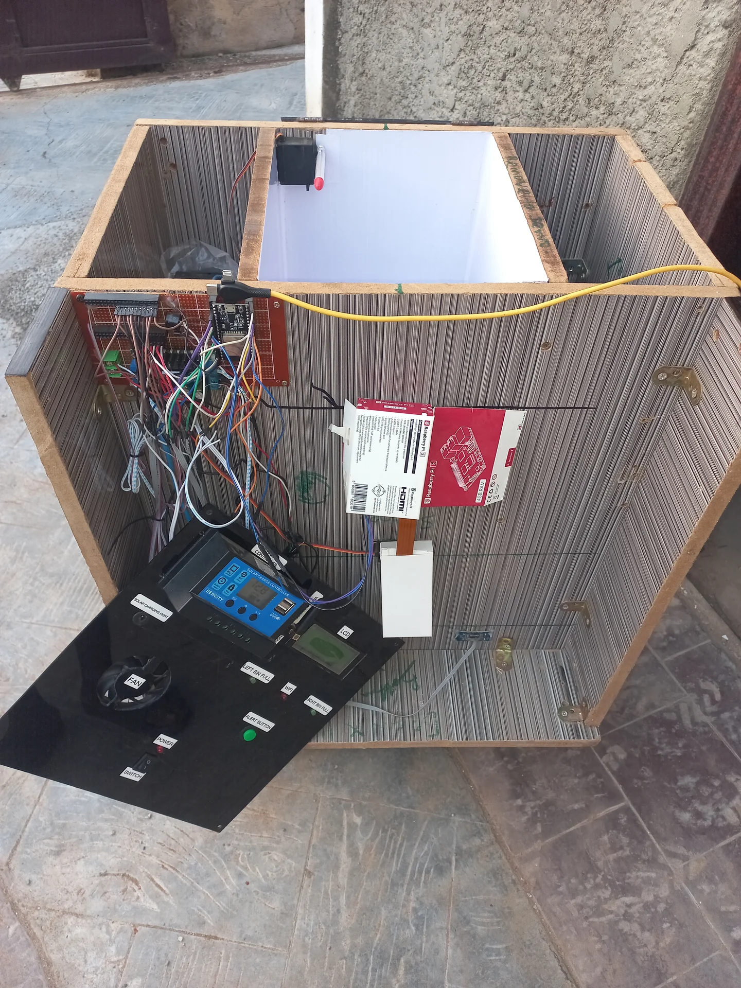 The full electronics bay with every component wired up: ESP32, Pi, SIM800L, relay, charge controller and power rail