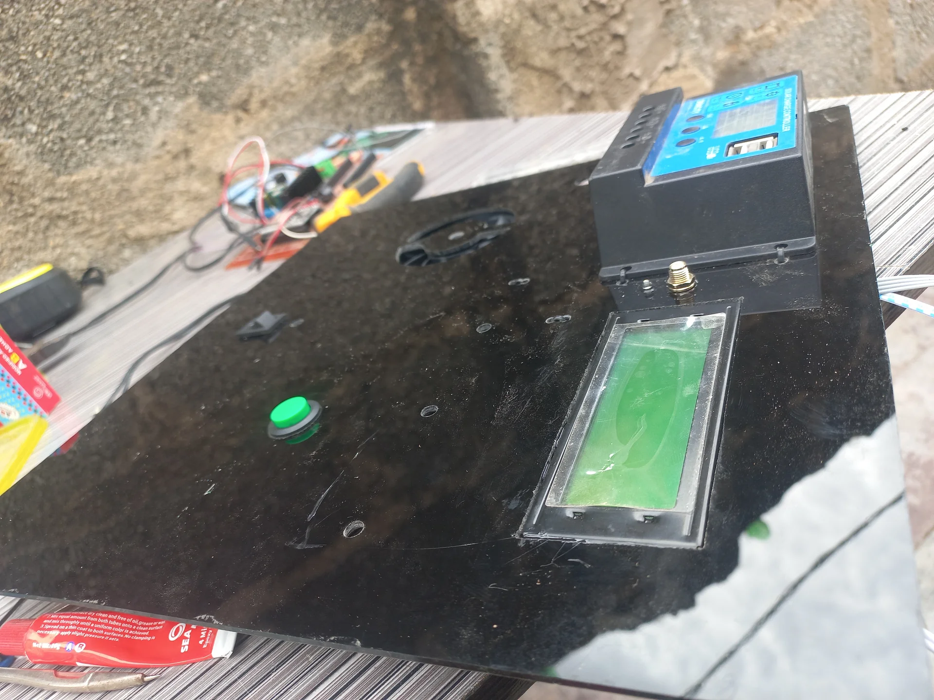 Front face of the panel showing the LCD display, charge controller screen and the reset button together