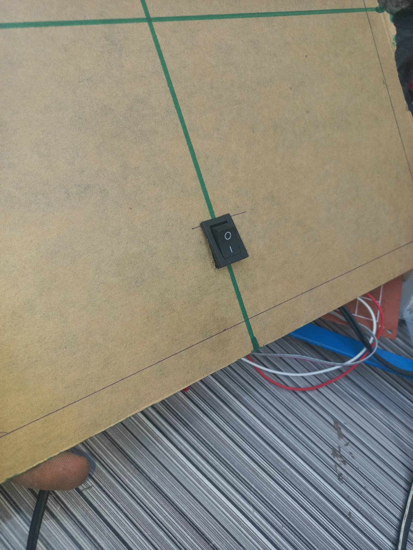 Rocker switch fitted into its rectangular cutout in the panel, photographed from the front