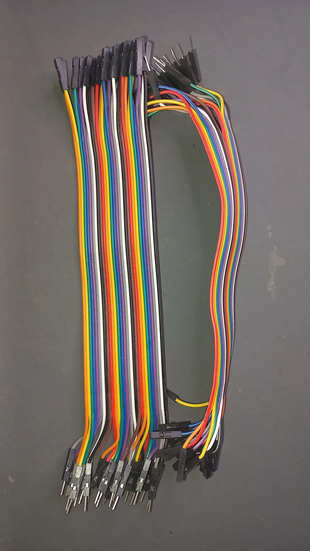 Bundle of multicolour male-to-female jumper wires (Dupont cables) used for prototyping connections