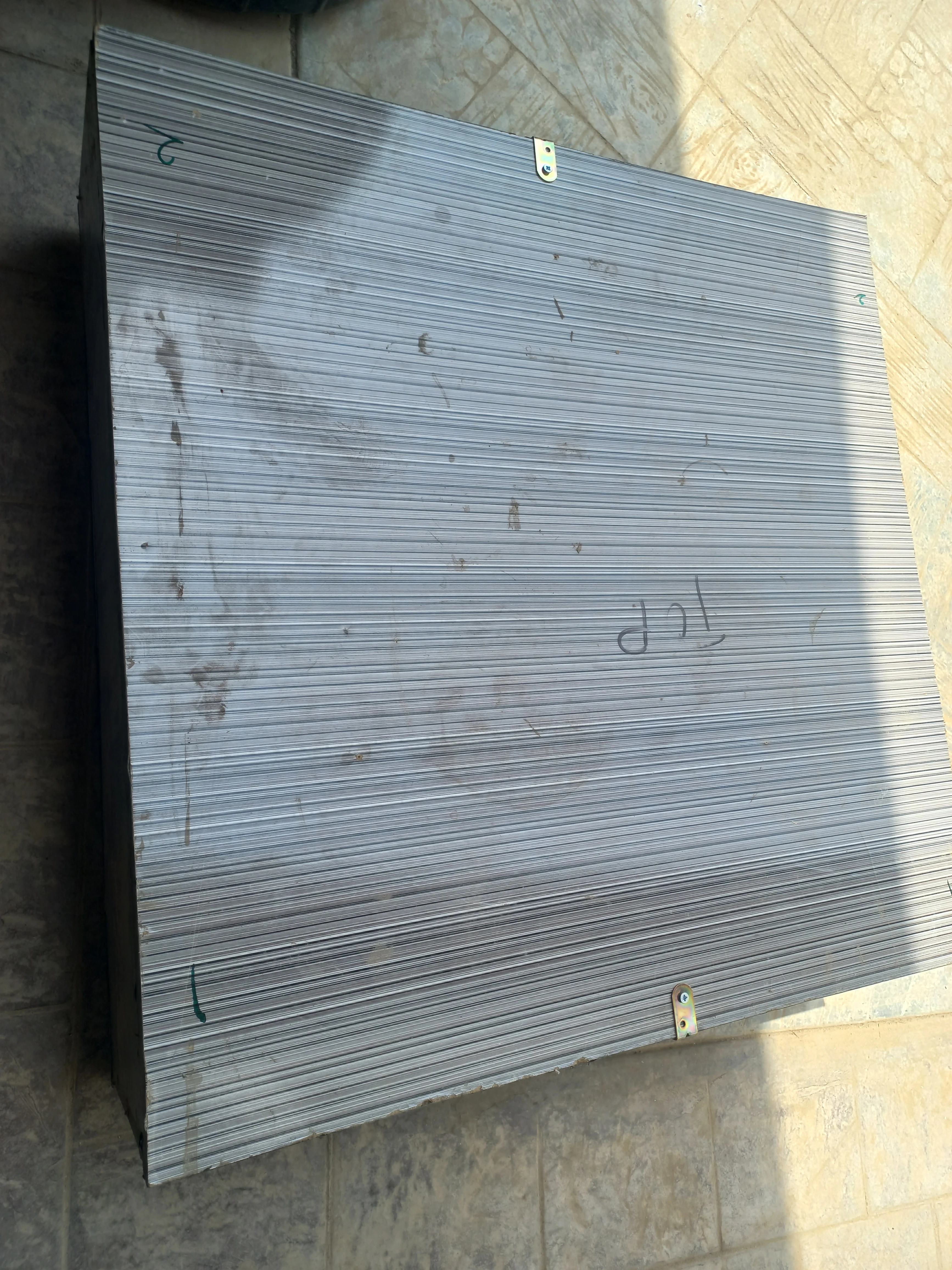 Composite board stack with metal corner brackets for assembly
