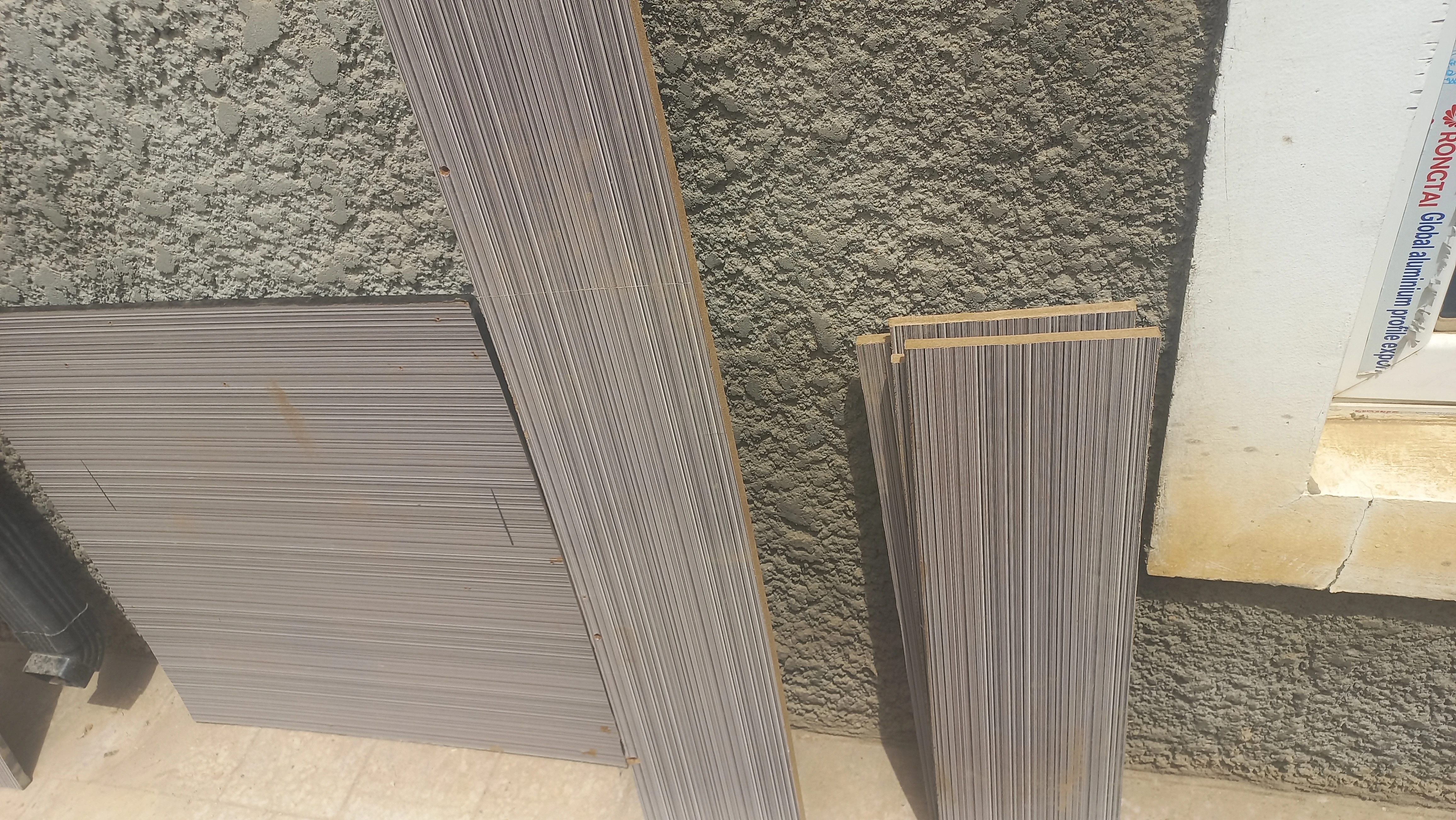 Cut composite panels leaning against wall