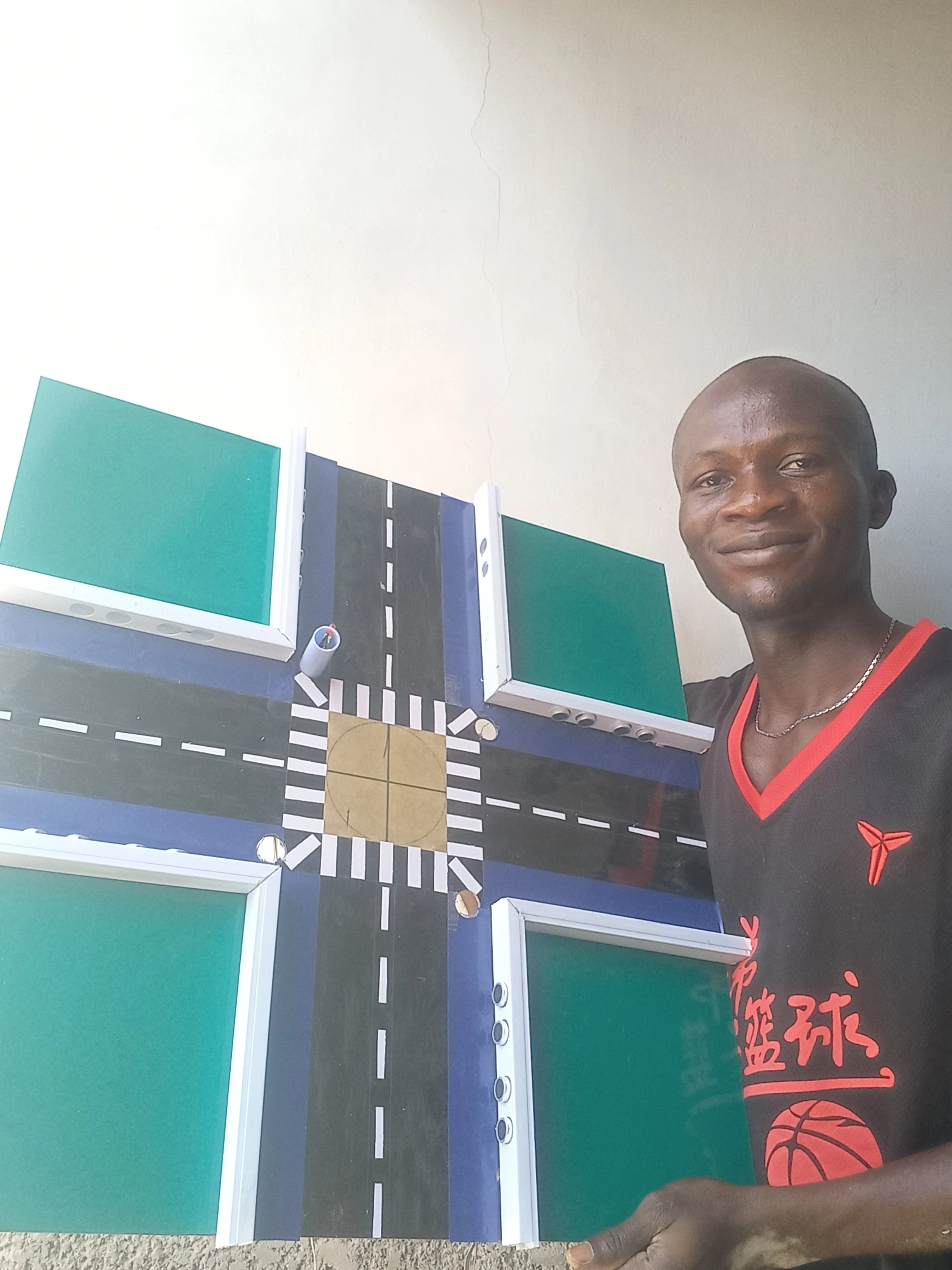 Developer with road model showing traffic light positions — view 3