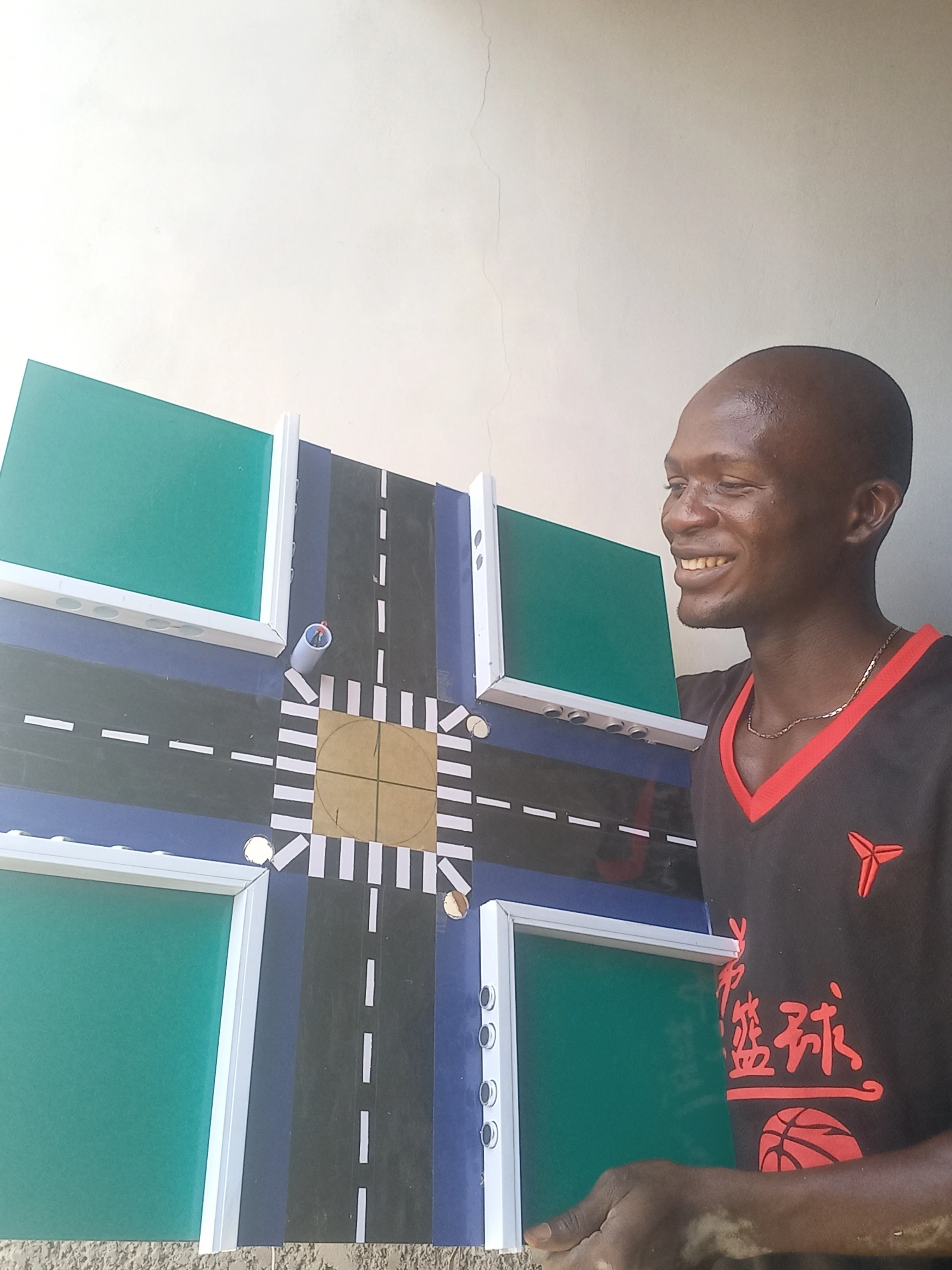 Developer with road model showing traffic light positions — view 4