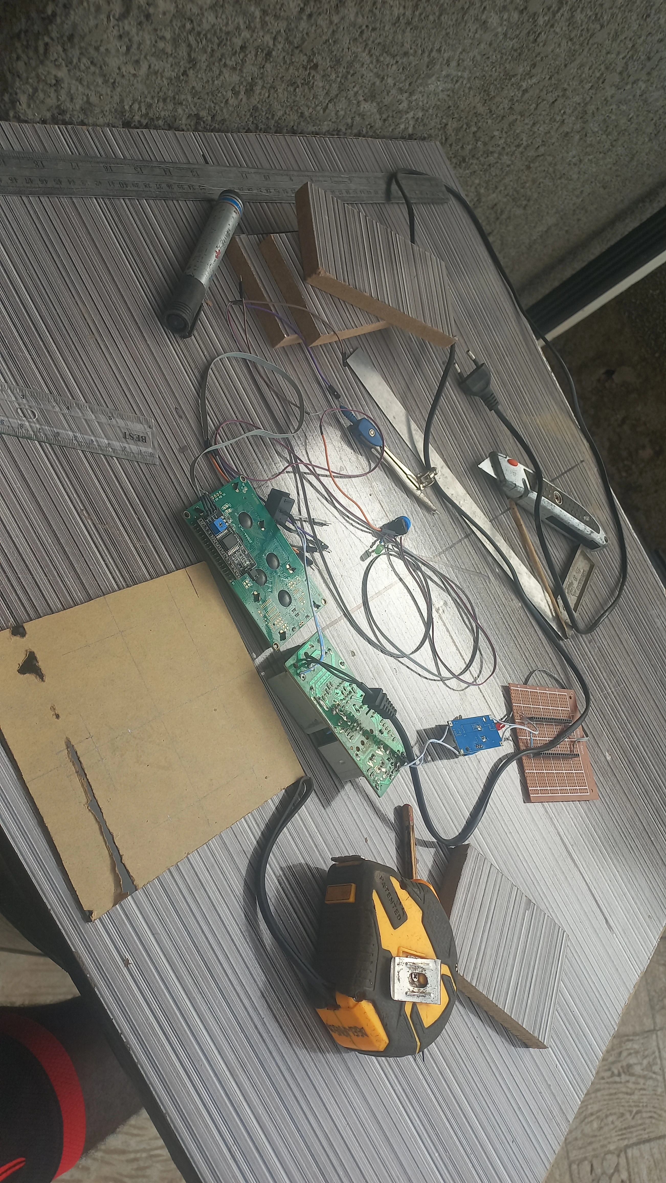 Electronics workbench during early enclosure preparation — angle 1