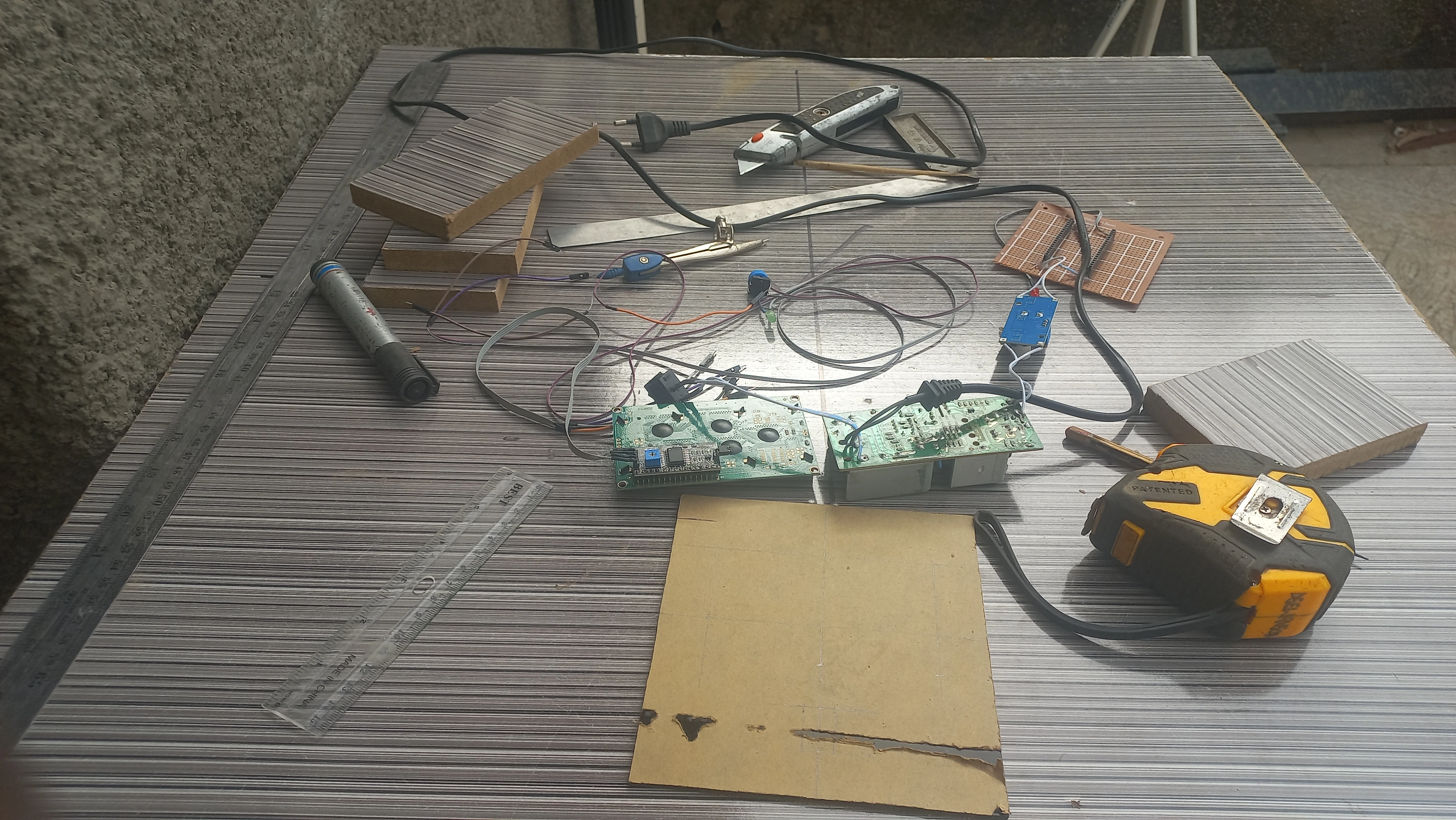 Electronics workbench during early enclosure preparation — angle 2