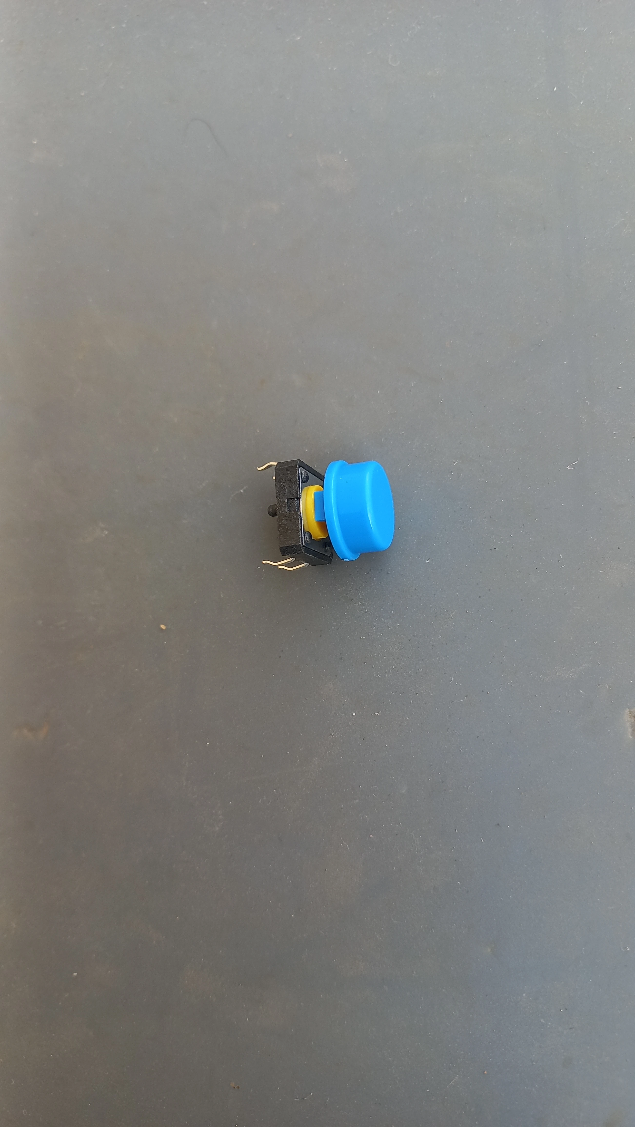 Tactile push button for emergency override — top view