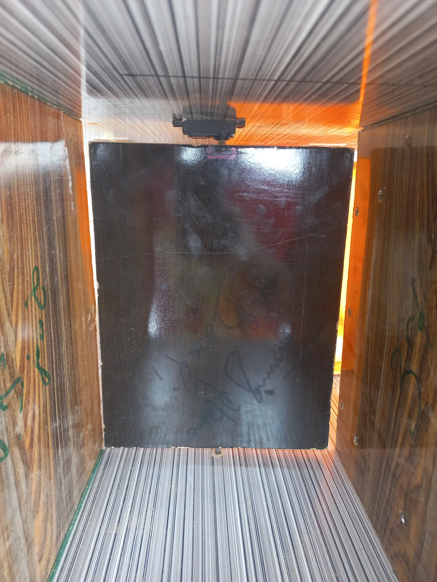 One of the bin compartments with the black-painted sorting flap visible inside