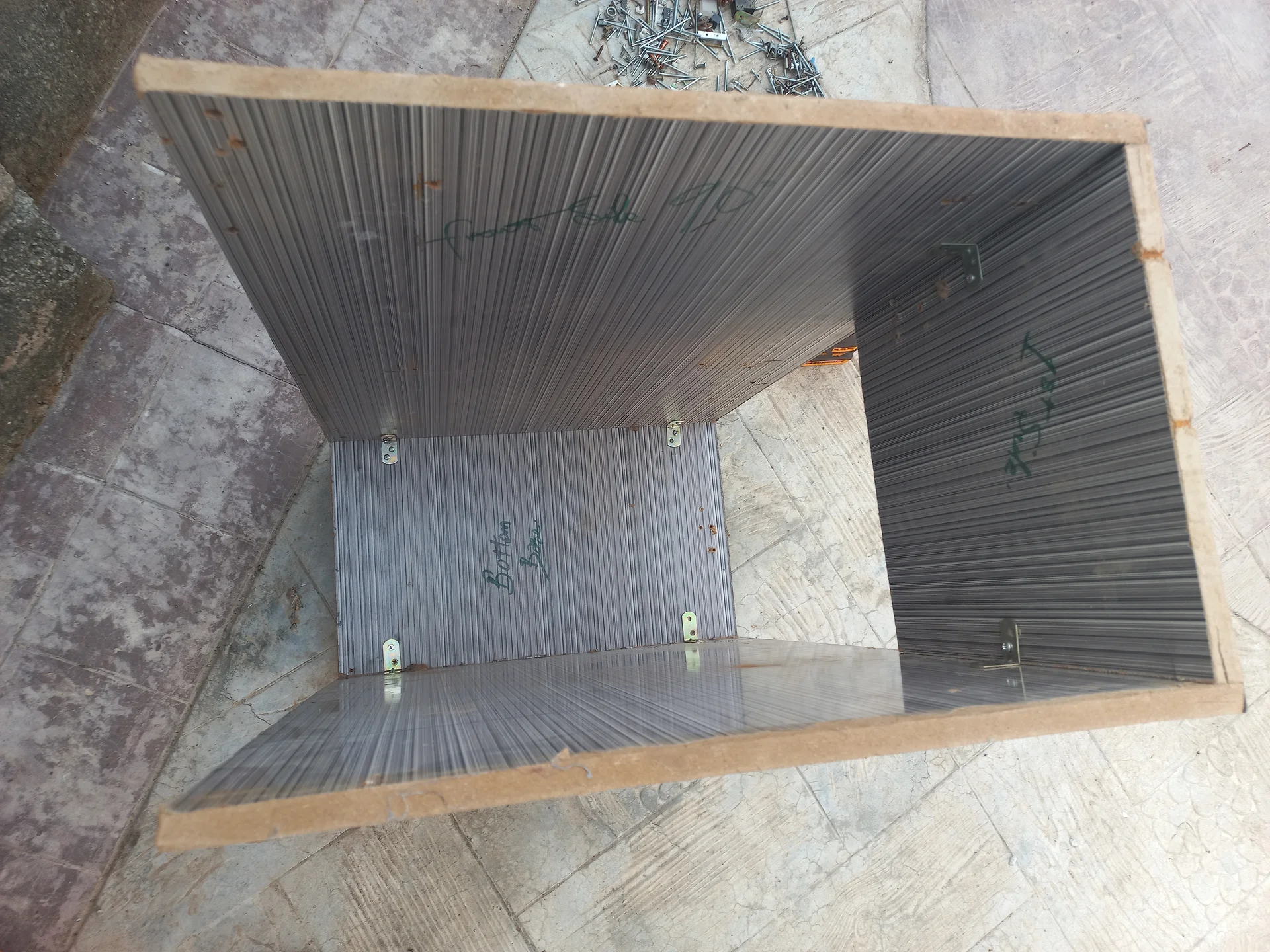 Top-down view into the open bin showing the central divider panel creating two compartments, with metal mounting brackets on the interior walls