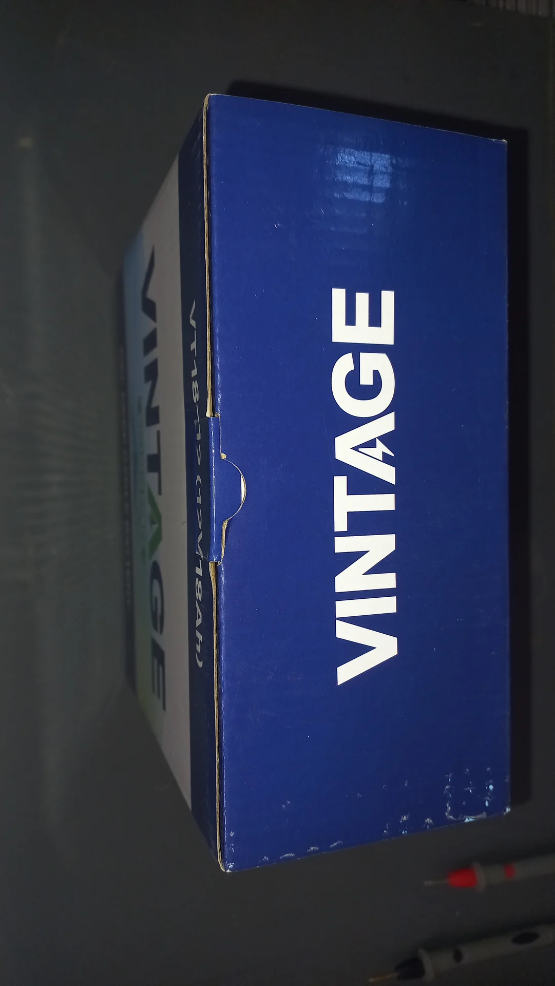 Side view of the VINTAGE VT18-12 battery box showing the blue VINTAGE branding on the top face