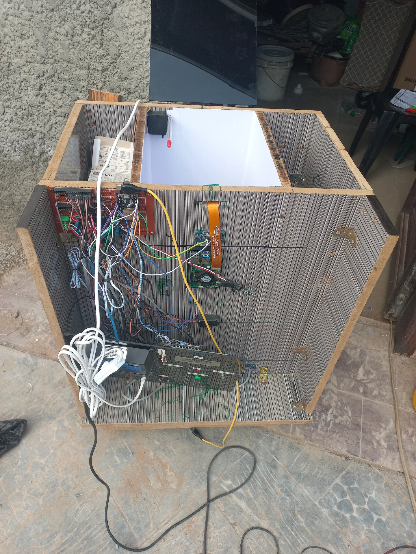 Electronics bay photographed from the open side, showing the full wiring harness before cable management