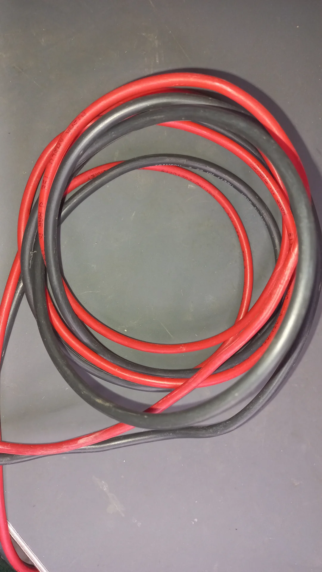 A coil of thick red and black silicone power wires, used for the high-current battery connections