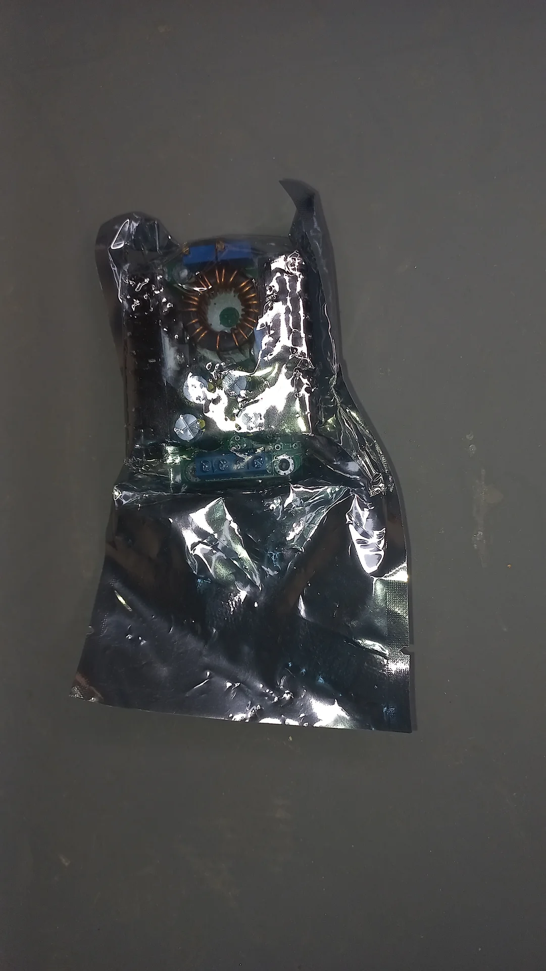 DC-DC buck converter module inside an anti-static protective bag as received during delivery