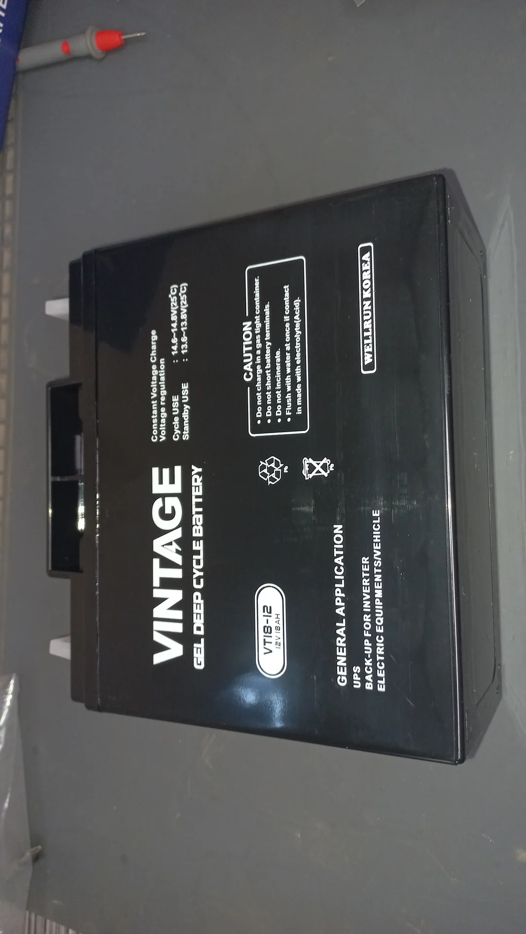 VINTAGE VT18-12 battery from a side angle showing the spec label, caution notice and Wellbun Korea branding