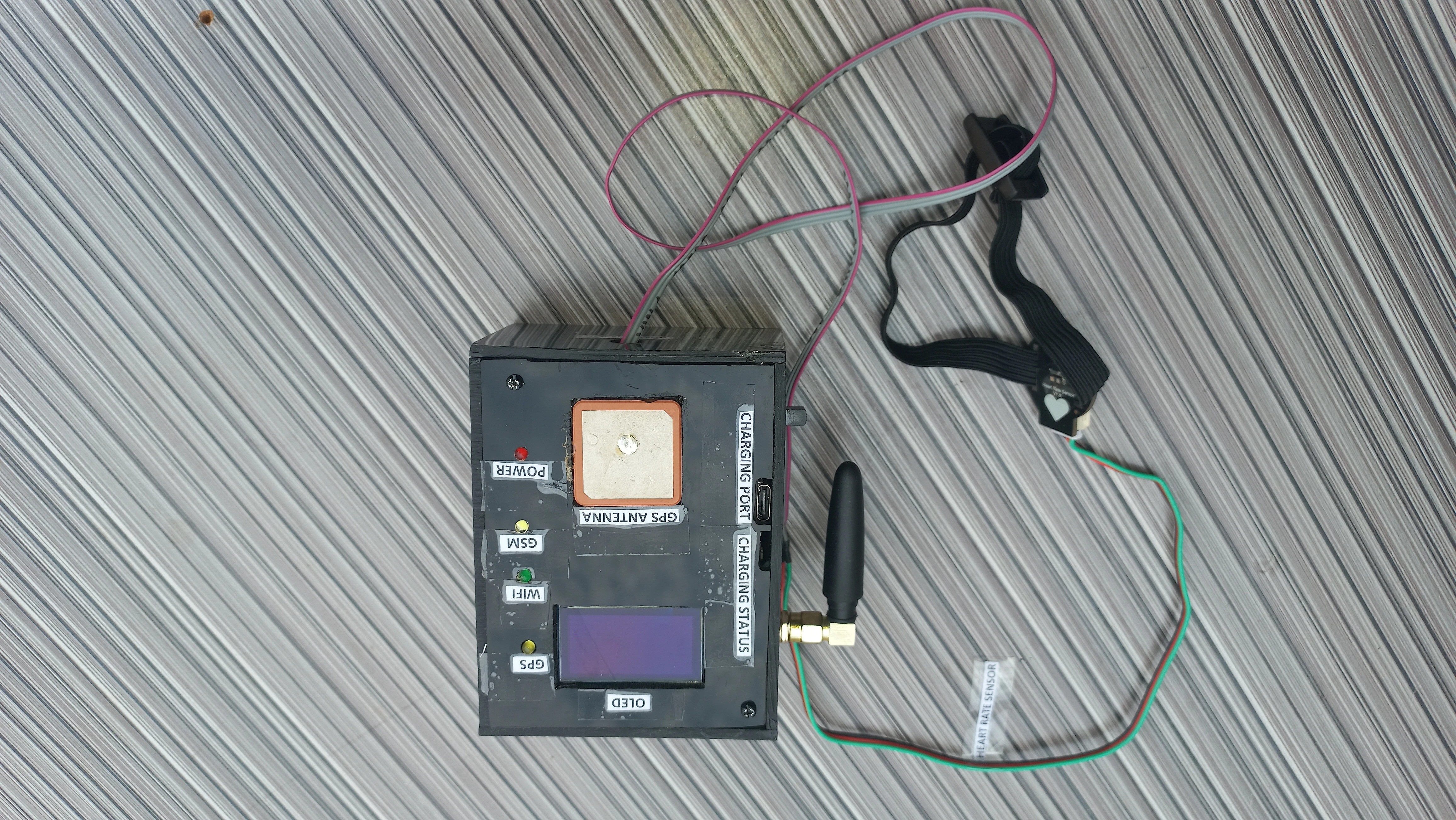 Completed device front showing OLED, LEDs, antennas