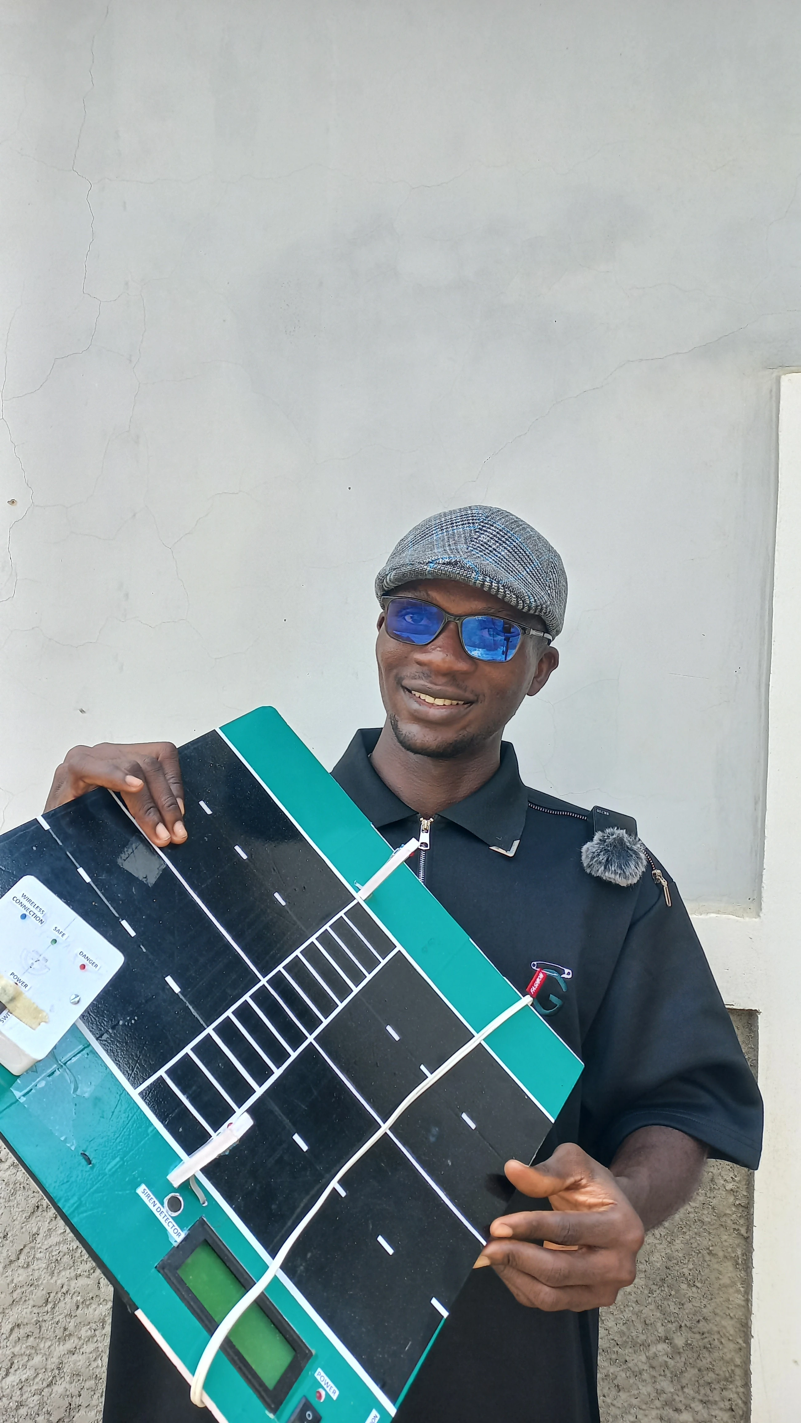 Developer pointing at the traffic light on the road model while holding the wearable unit: complete system demonstration