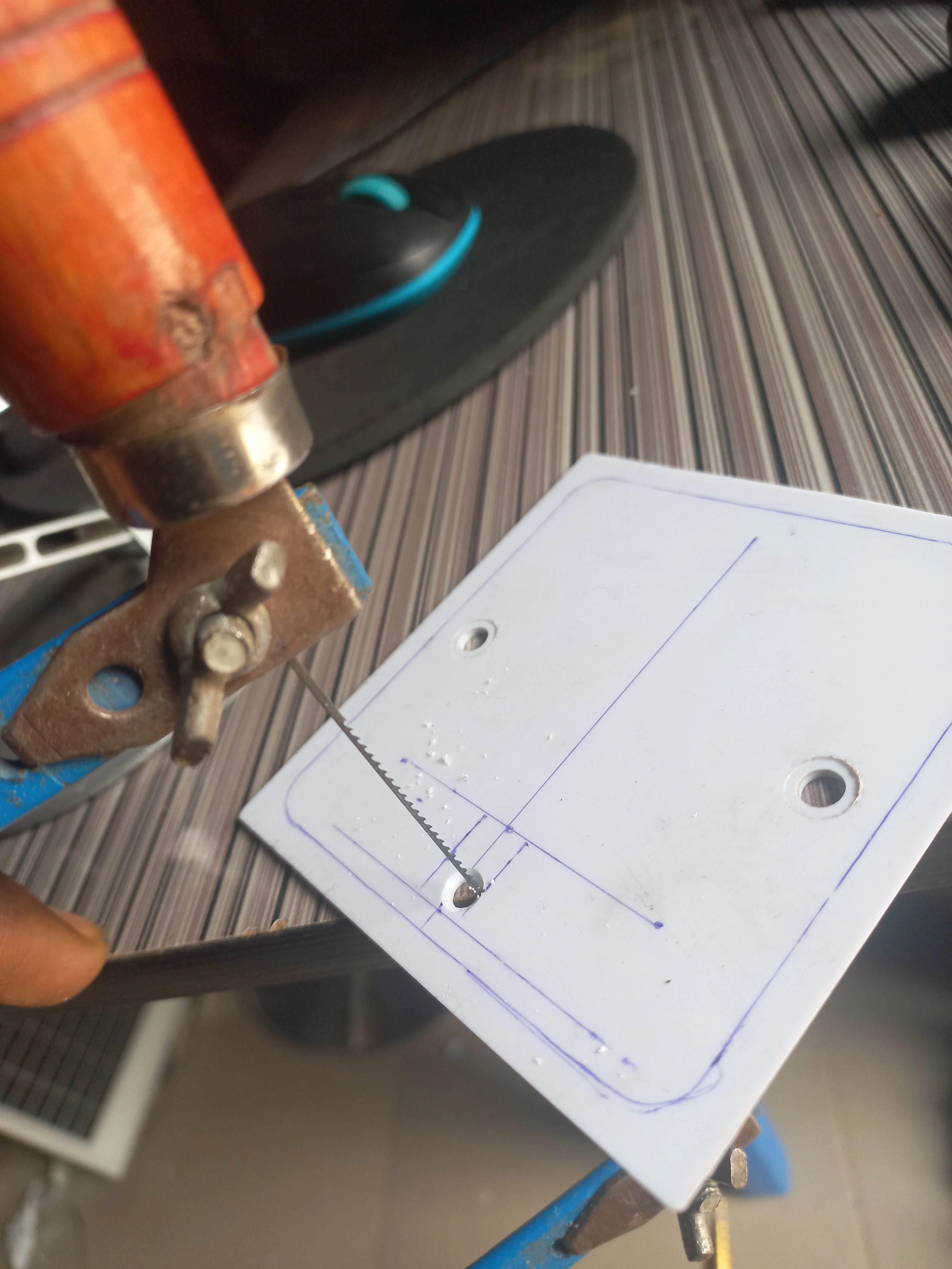 Angled view of the enclosure panel cutting operation showing the cut in progress